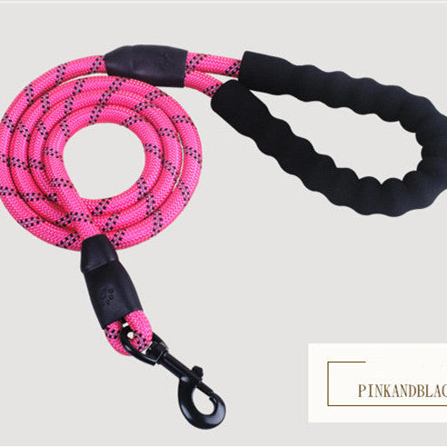 Pink and black dog leash on a light gray background
